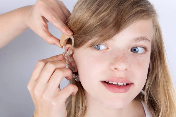 Young girl trying hearing aids — Stock Photo, Image