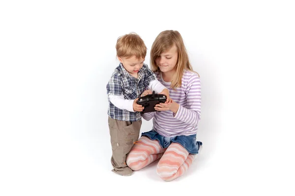 Young girl showing the drone remote control to her small brother — Stock Photo, Image