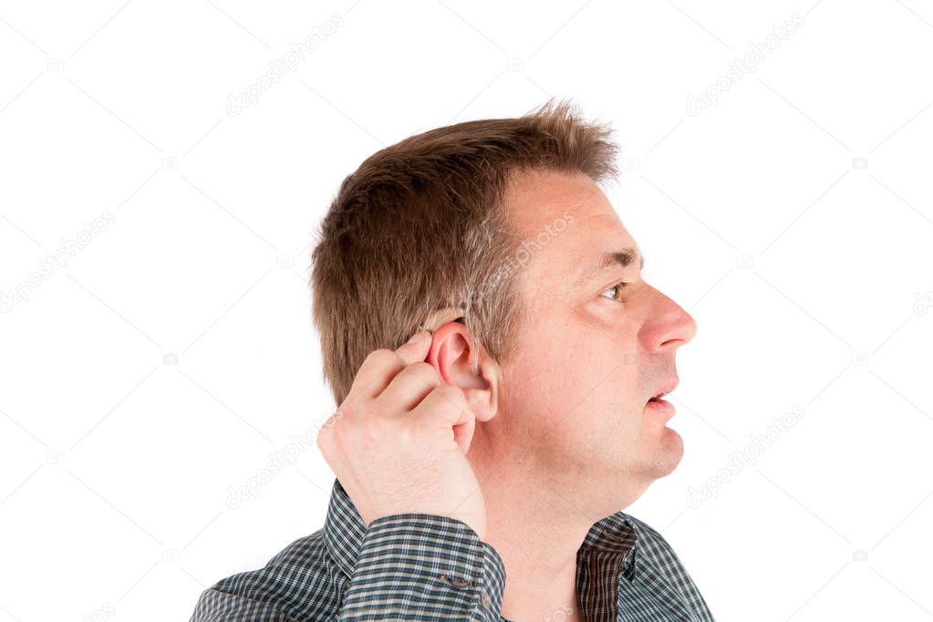 Middle-aged deaf man testing a hearing aid