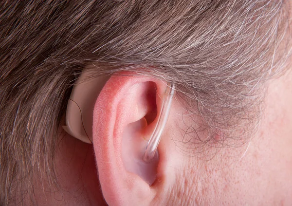 Close-up of a senior man's ear wearing hearing aid — Stock Photo, Image