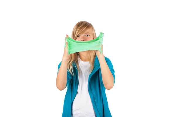 Funny girl holding green slime looks like gunk in front of her f — Stock Photo, Image