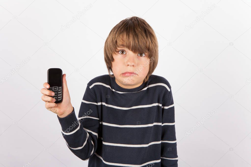 Young boy showing a simple phone is very upset because he would 
