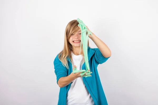 Funny girl playing with green slime looks like gunk — Stock Photo, Image