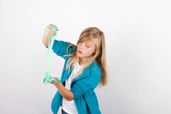 Girl playing with gunk-like green slime