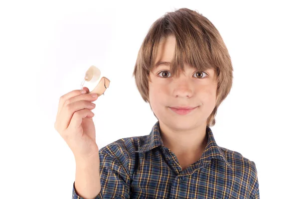 Lindo chico mostrando un audífono. Aislado sobre fondo blanco — Foto de Stock