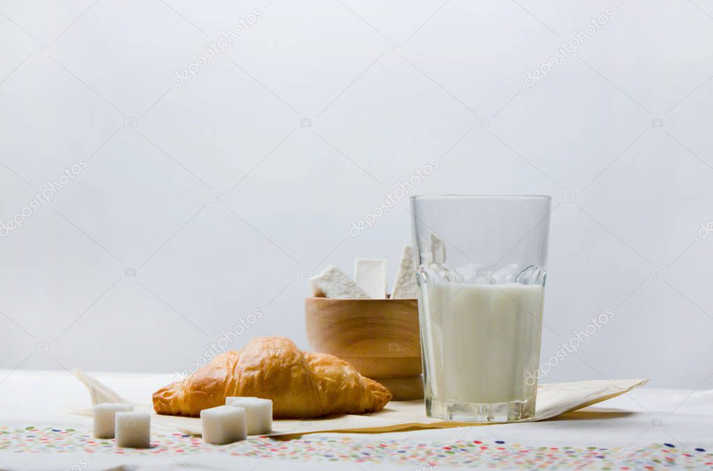 Studio subject milk with a bun croissant