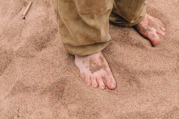 Barefoot male legs on sand — Stock Photo, Image