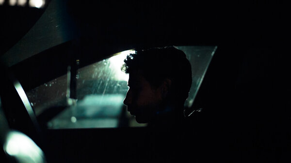 Profile of a man in  car on  dark night.