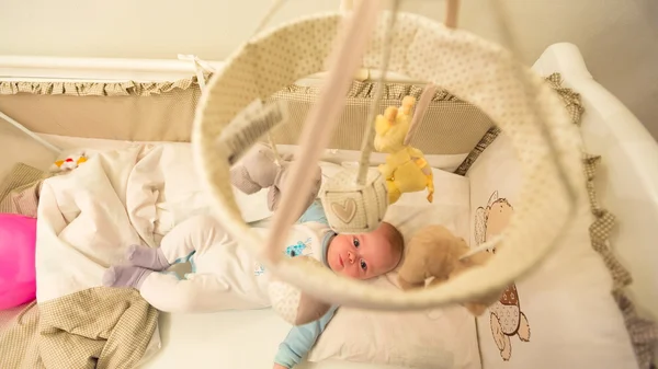 Baby lying in his cot — Stock Photo, Image