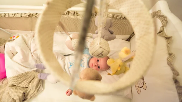 Baby lying in his cot — Stock Photo, Image