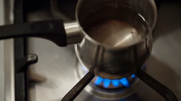 Ladle of water heated — Stock Video