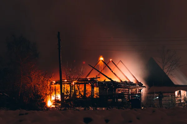 fire in a wooden house at night - Stock Image - Everypixel