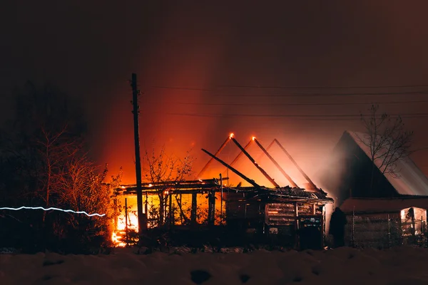 Fire in a wooden house at night — Stock Photo, Image