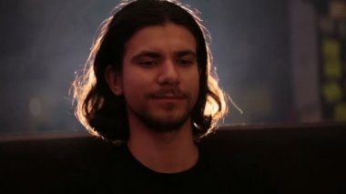 Bir barda oturan genç yakışıklı adam