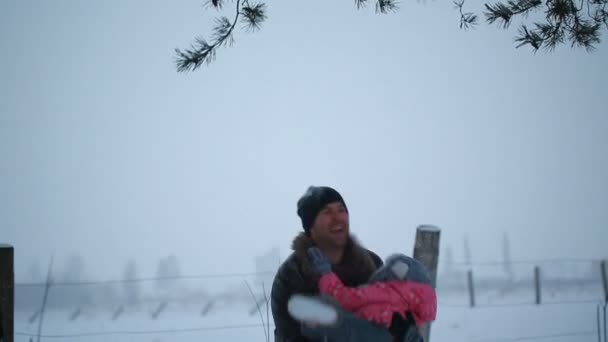 Padre lanza sus manos sobre su hija en el parque de invierno — Vídeos de Stock