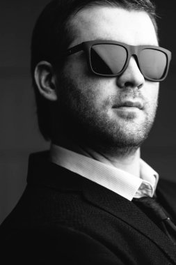 karanlık bir odada güneş gözlüklü adam