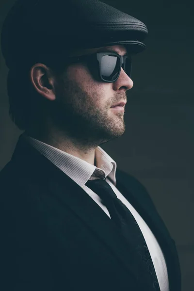 Man in sunglasses and a leather cap — Stock Photo, Image