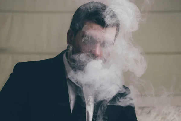 Mysterious businessman in smoke — Stock Photo, Image