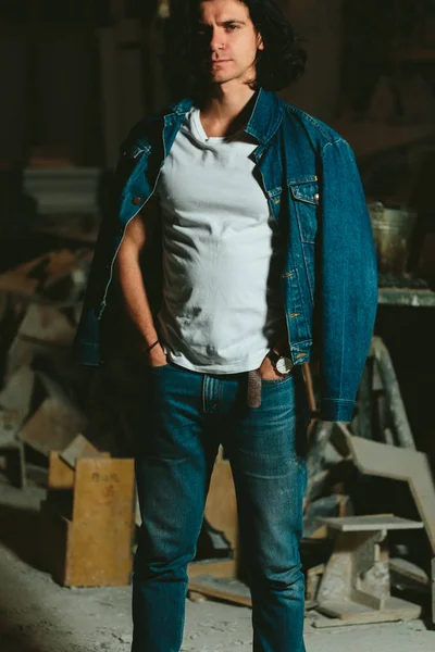 handsome man with long hair brunette in a denim jacket