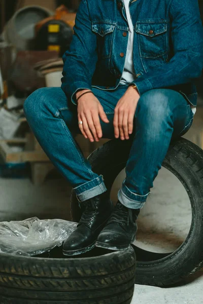 handsome man with long hair brunette in a denim jacket