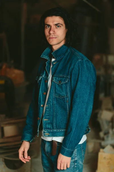 handsome man with long hair brunette in a denim jacket