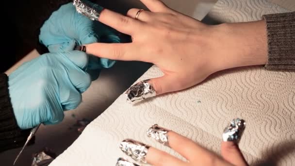 Салон нігтів. Манікюрник видалив старий лак для нігтів з клієнтом — стокове відео