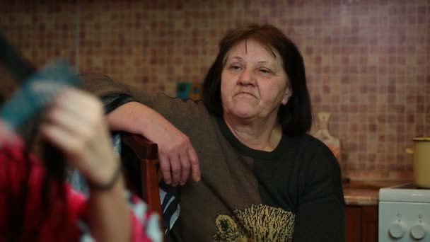 Elderly woman looks like a comb and her daughter — Stock Video