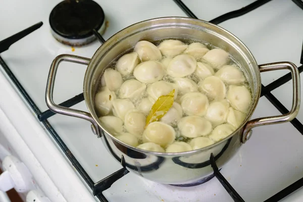 stock image dumplings boiled in a pot.