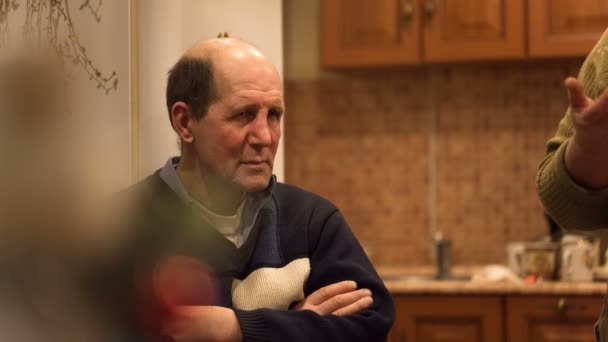 Man aged sits listening to the funny story — Stock Video