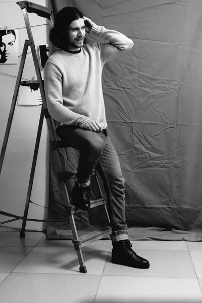 Guy posing in a stepladder — Stock Photo, Image