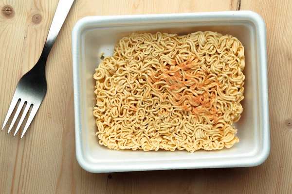 Instant noodles on a wooden table.