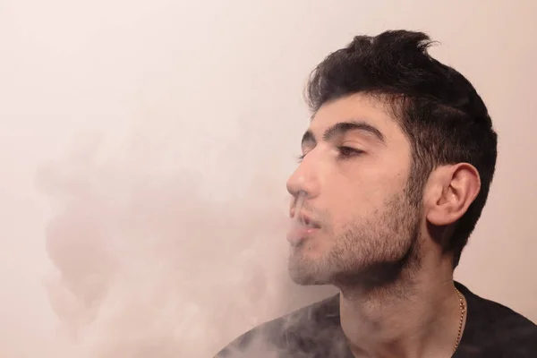 Joven libera mucho humo . — Foto de Stock