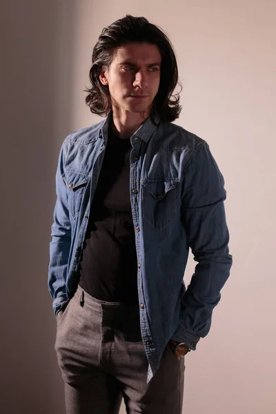 Bellissimo uomo con i capelli lunghi in camicia di jeans . — Foto Stock
