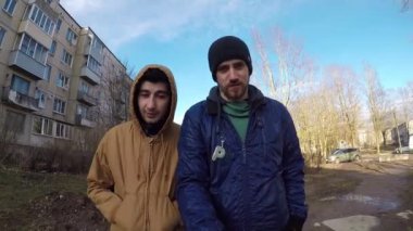 İki arkadaş sonbaharda cadde boyunca yürüyor