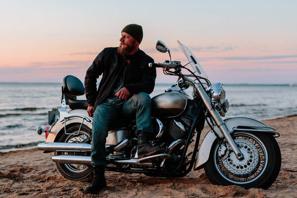 Biker on the beach at sunset