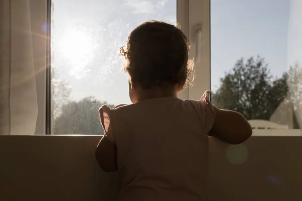 Little child by the window — Stock Photo, Image