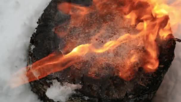 Ice on a wooden stump melts under a stream of fire in slow motion — Stock Video