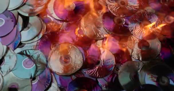 Compact discs melt under the powerful hot flame of fire — Stock Video