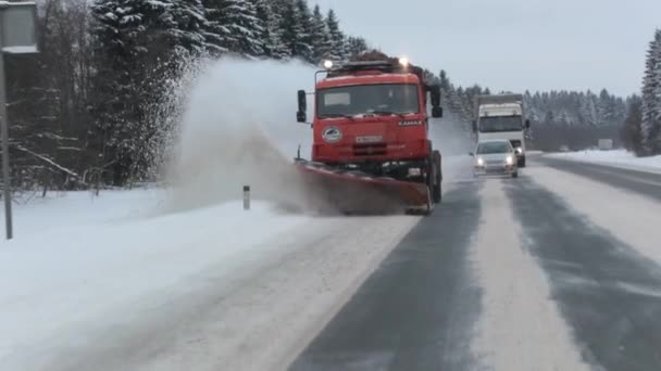 Snow-removing machine removes snow from the road. front view. Slow motion — Stock Video