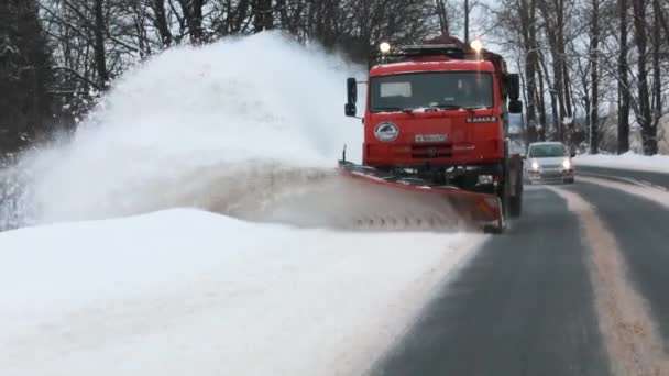 Snow-removing machine removes snow from the road. front view. Slow motion — Stock Video