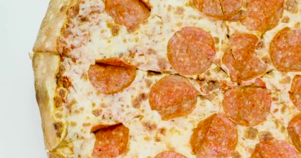 Pepperoni pizza revolves around its axis — Stock Video