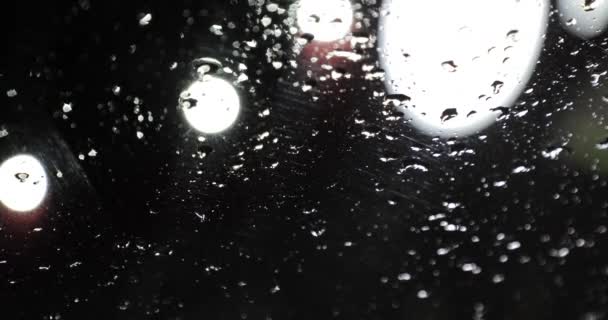 Drops of rain on the glass at night — Stock Video