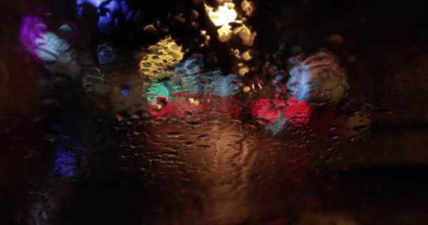 Drops of rain on the glass at night — Stock Video