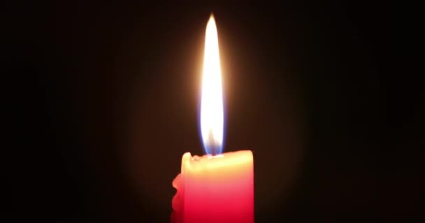 Κόκκινο κερί καίγεται στο σκοτάδι — Αρχείο Βίντεο