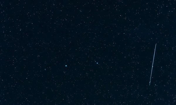 Cielo estrellado azul con una estrella que cae — Foto de Stock