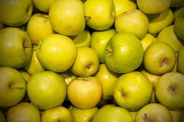 Fresh apples spread out an even layer as a background.