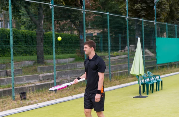 Junge männliche Tennisspielerin wärmt sich in Sportkleidung auf — Stockfoto