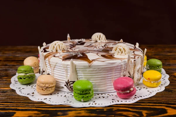 Close up of cake with different chocolate ornaments on wooden de — Stock Photo, Image