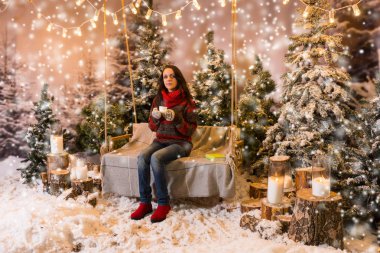 Sevimli kadın flashligh altında bir battaniye ile bir salıncak üzerinde oturuyordu