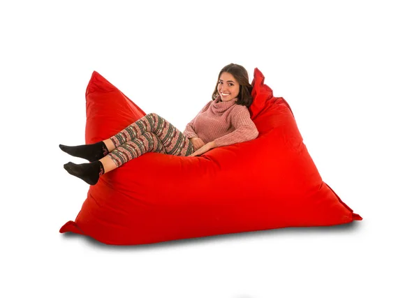 Wanita muda cantik berbaring di kursi sofa beanbag berbentuk persegi merah — Stok Foto